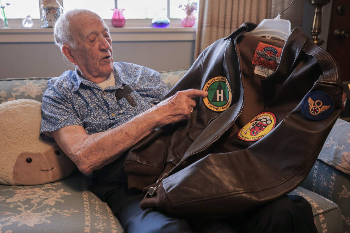 George Roberts, 100, showed a replica of his bomber jacket he wore while in the U.S. Army Air Force as a radio operator during World War II, completing 31 bombing missions over Germany. The original is now in a museum.
