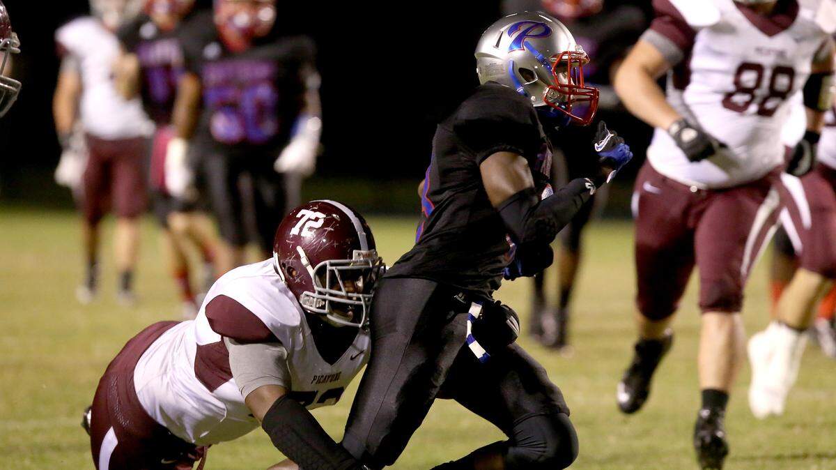 AMANDA McCOY/SUN HERALD 
 Picayune's Louis Graham tackles Pascagoula's Cartreal Davison on Friday, October 30, 2015, at Pascagoula High.