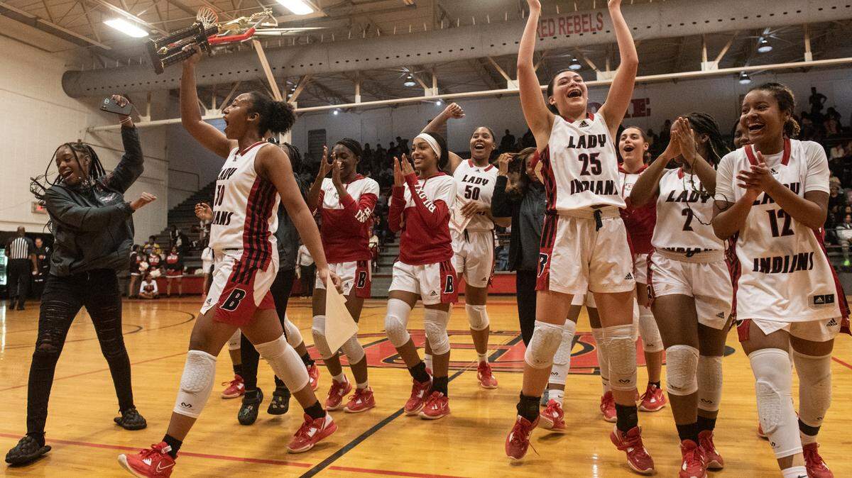 The Biloxi Lady Indians celebrate their win over Harrison Central to win the district title at Harrison Central High School in Gulfport on Friday, Feb. 10, 2023.