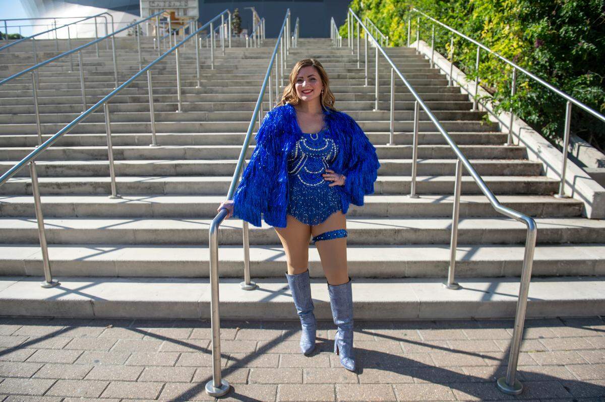Mia Minnick, of Tennessee, shows off her outfit outside the Cesars Superdome in New Orleans on Friday, Oct. 25, 2024, before Taylor Swift’s Eras Tour performance that night.