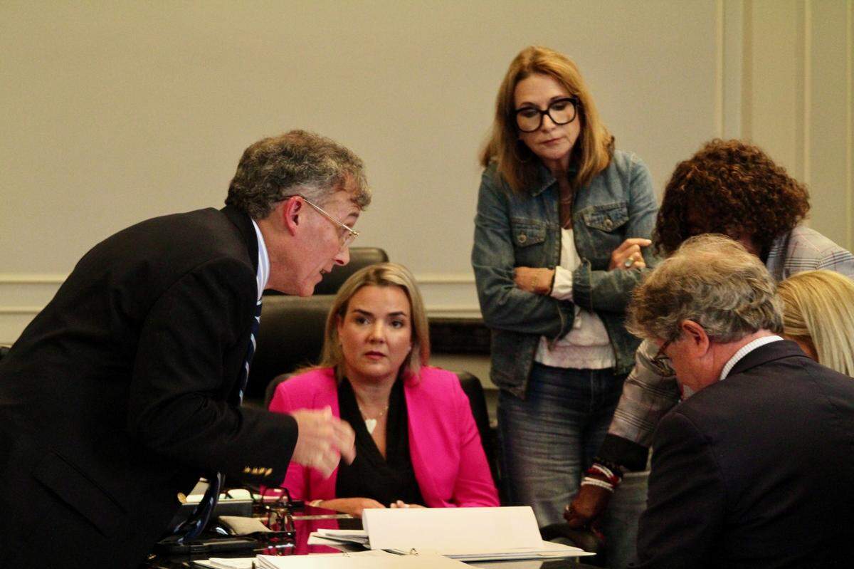 City attorney Jeff Bruni, left, consults with members of the Gulfport Municipal Election Commission during a challenge to the candidacy of Ward 3 City Council incumbent Ella Holmes-Hines, a Democrat. Commission members Stephanie Norris, seated, and Cindy Creel, standing, look on.