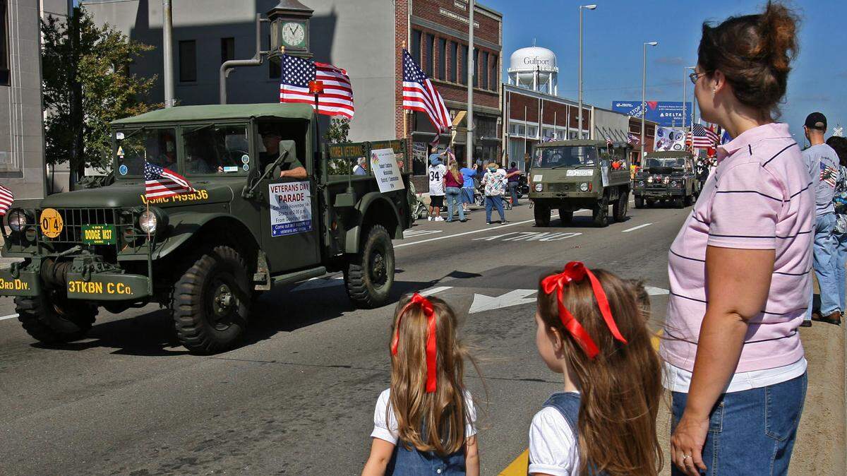 WILLIAM COLGIN/SUN HERALDVeterans driving historic vehicles roll through the streets of downtown Guflport during a past Gulf Coast Veterans Day parade. This year's parade is Saturday.