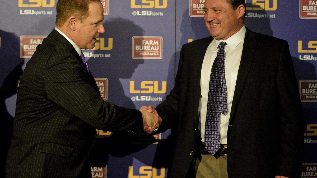 HILARY SCHEINUK/ASSOCIATED PRESS 
 LSU defensive line coach Ed Orgeron, right, shakes hands with LSU head coach Les Miles in January.