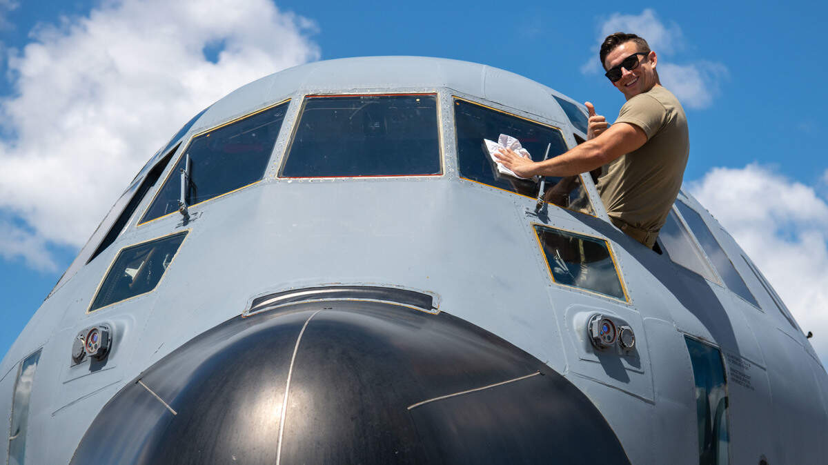 Staff Sgt. Kyle Stoeger, of the 403rd Aircraft Maintenance Squadron at Keesler Air Force Base, Miss., cleans a WC-130J assigned to the 53rd Weather Reconnaissance Squadron’s windows after it returned to Keesler from San Antonio Aug. 31, 2021. The squadron evacuated from Keesler ahead of Hurricane Ida’s landfall.