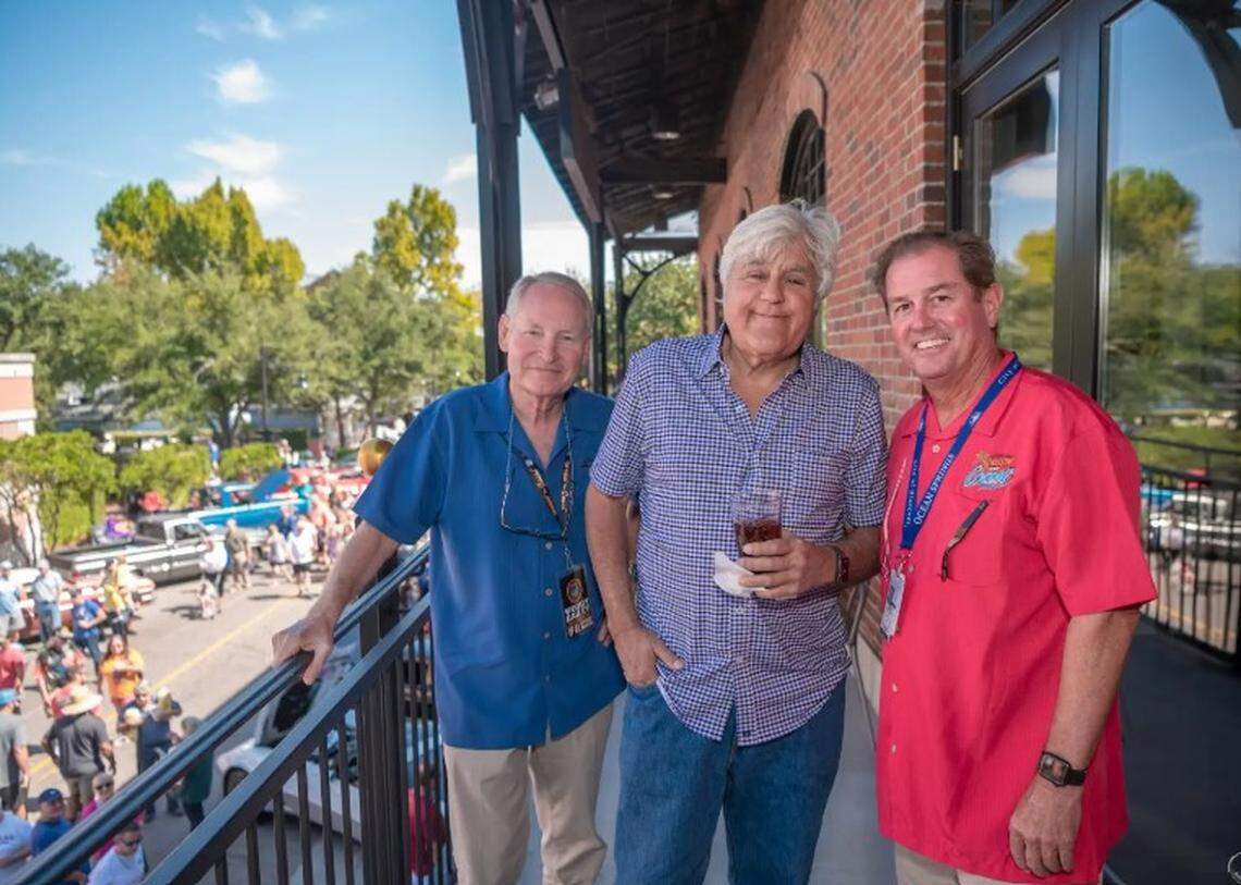Cruisin’ The Coast Executive Director Woody Bailey, left, hangs out with comedian and car buff Jay Leno and former Ocean Springs Mayor Kenny Holloway, right, during a Cruisin’ event in 2022 in downtown Ocean Springs.