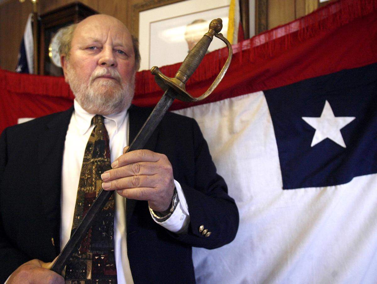 Charles Sullivan looks through the hilt of a sword belonging to Sgt. William Doyle of the 9th Connecticut Infantry which captured the flag to the 3rd Mississippi Infantry at a skirmish in Pass Christian. Sullivan will take the sword to Vicksburg next week for the unveiling of a 9th Connecticut monument at the Vicksburg National Military Park.
