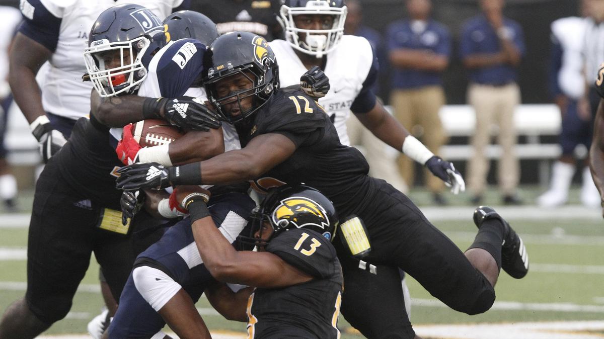 Southern Miss defense backs D.Q. Tjhomas(12) and Picasso Nelson Jr. hit Jackson State running back Jordan Johnson during the second quarter of their game at M.M. Roberts Stadium in Hattiesburg on Saturday, Sept. 1, 2018.