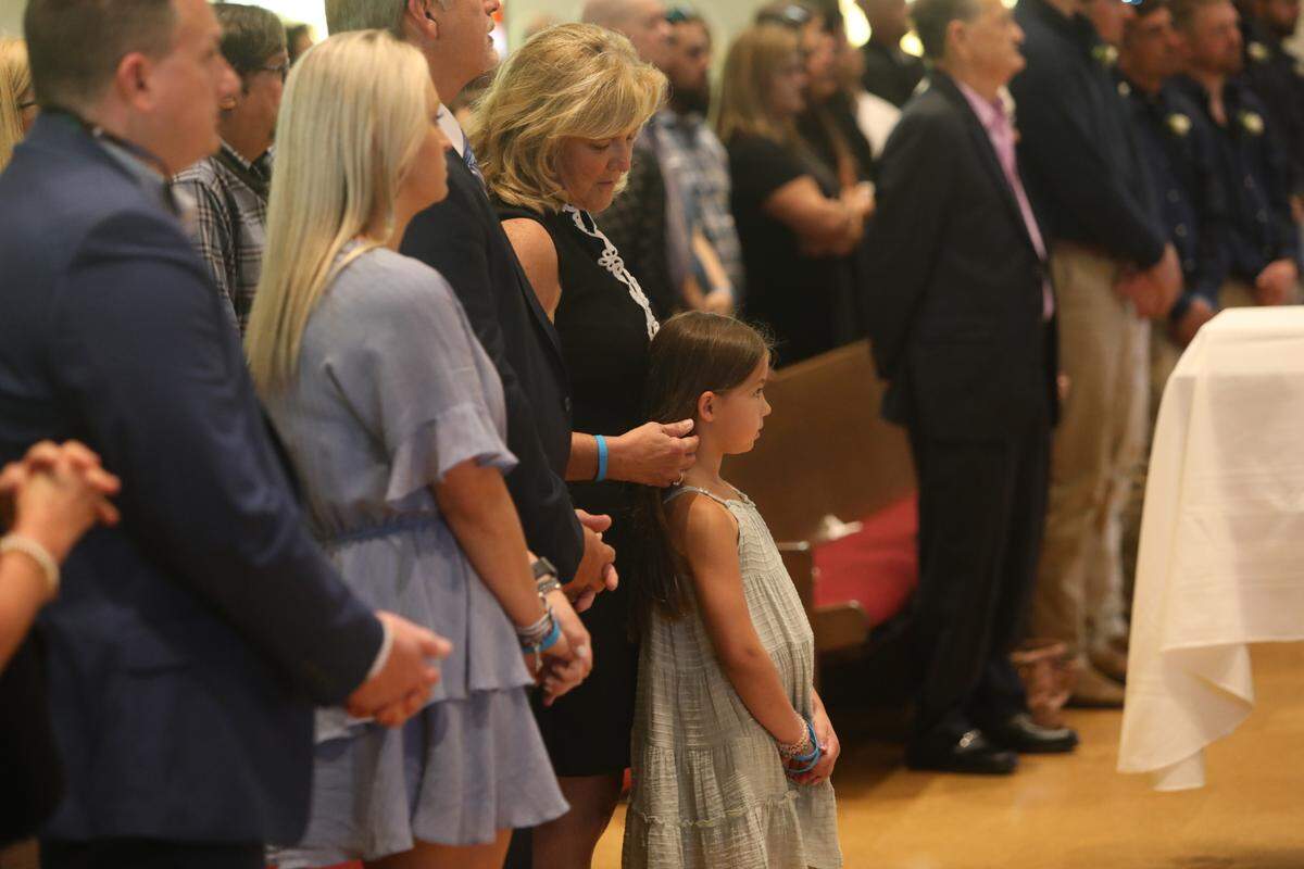 Michele Seal pulls back Anistyn Hoda’s hair during Cayce Seal’s funeral services at St. Clare Catholic Church on July 1, 2021.