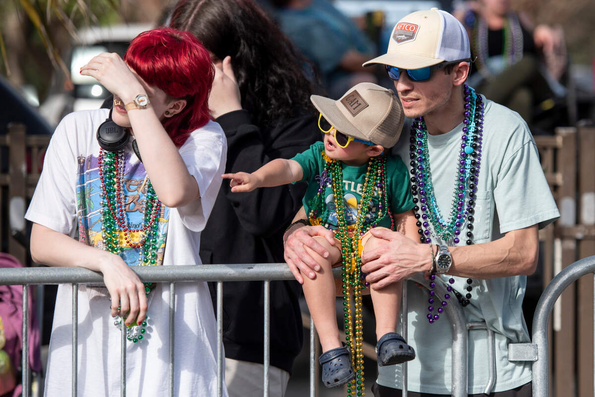 Parade watchers cheer for throws during the Ocean Springs Elks Club Mardi Gras Parade in Ocean Springs on Saturday, Feb. 15, 2025.