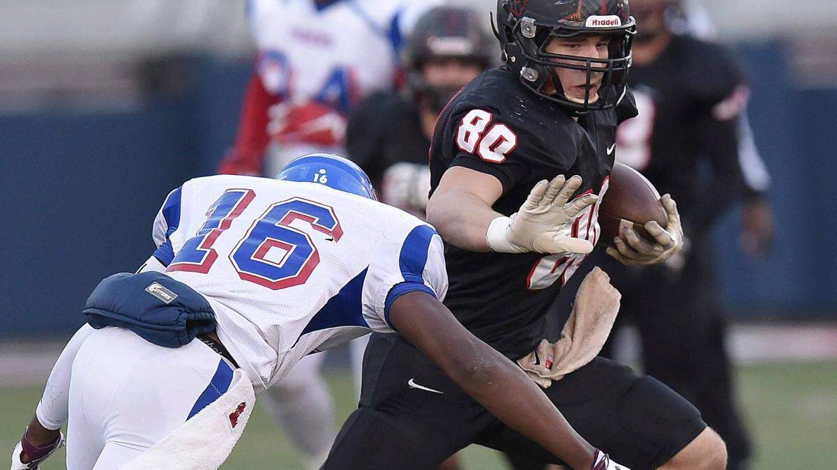 St. Stanislaus receiver Chase Rogers (80) uses a stiff arm against Noxubee County defender Daveon Ball (16) on Saturday, December 5, 2015, in the MHSAA Class 4A State Football Championship in Vaught-Hemmingway Stadium on the Ole Miss campus in Oxford, Miss.