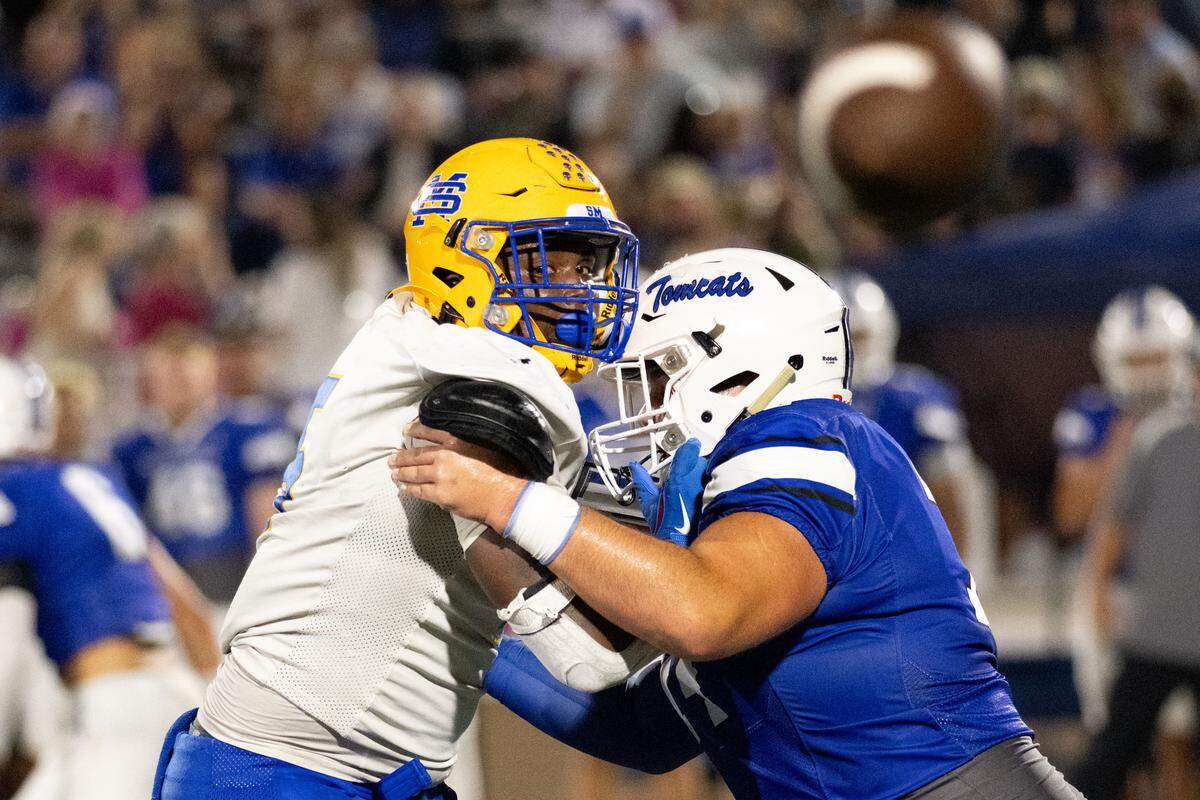 St. Martin defensive end Jayden Curtis (5) watches a Stone pass fly through the air while being blocked.