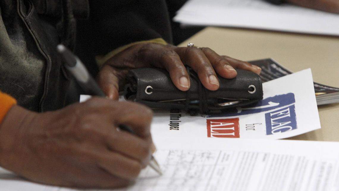 TIM ISBELL/SUN HERALDPeople sign petition asking for removal of the Confederate battle flag from the Mississippi state flag, Thursday, Feb. 11, 2016.