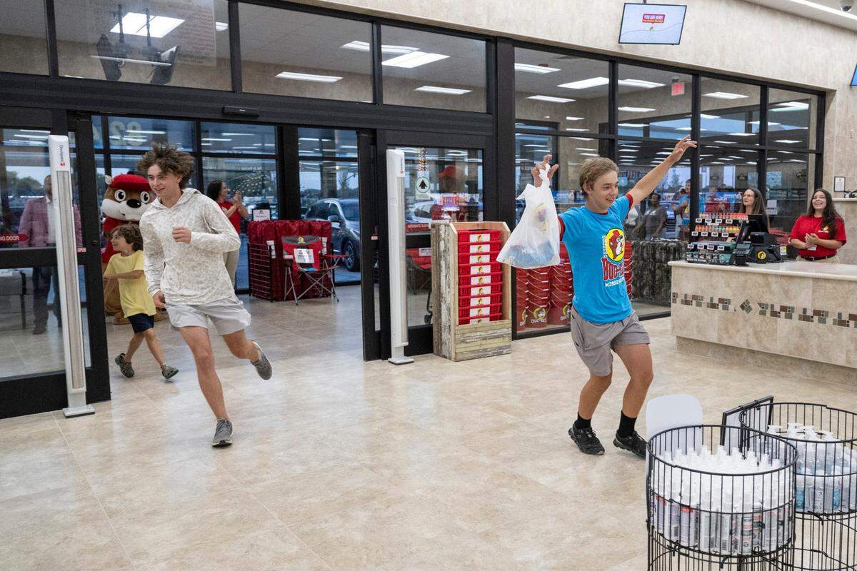 Peyton and Ayden Spear run into the new Mississippi Buc-ee’s location as the first customers of the Harrison County Buc-ee’s on Monday, June 9, 2025.