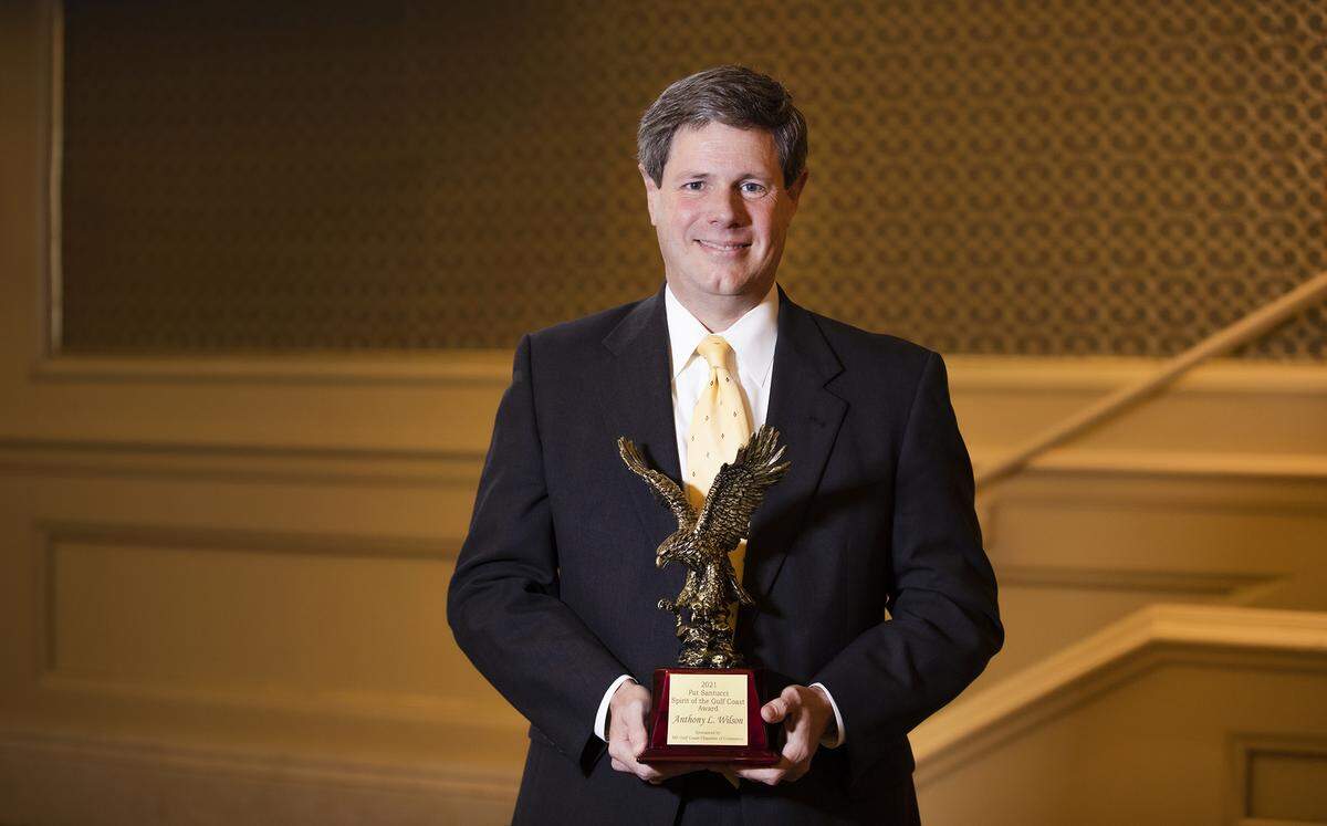 Mississippi Power President Anthony Wilson holds his “Spirit of the Coast” award Tuesday, Feb. 1, 2022, after it was presented at the Mississippi Coast Chamber of Commerce annual dinner at Beau Rivage Resort and Casino, Biloxi.