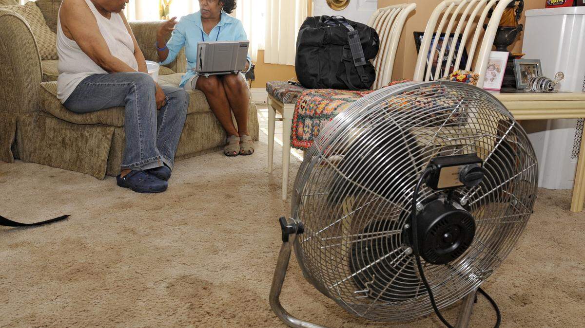 CLEM MURRAY/PHILADELPHIA INQUIRER/MCTVisiting nurse Monica Coleman, right, sits with patient Sandra Randolph, 67, in Randolph's Philadelphia, Pa., home in front of a fan. During heat waves, visiting nurses such as Coleman check up on their patients, taking vitals signs to make sure they are handing the heat.