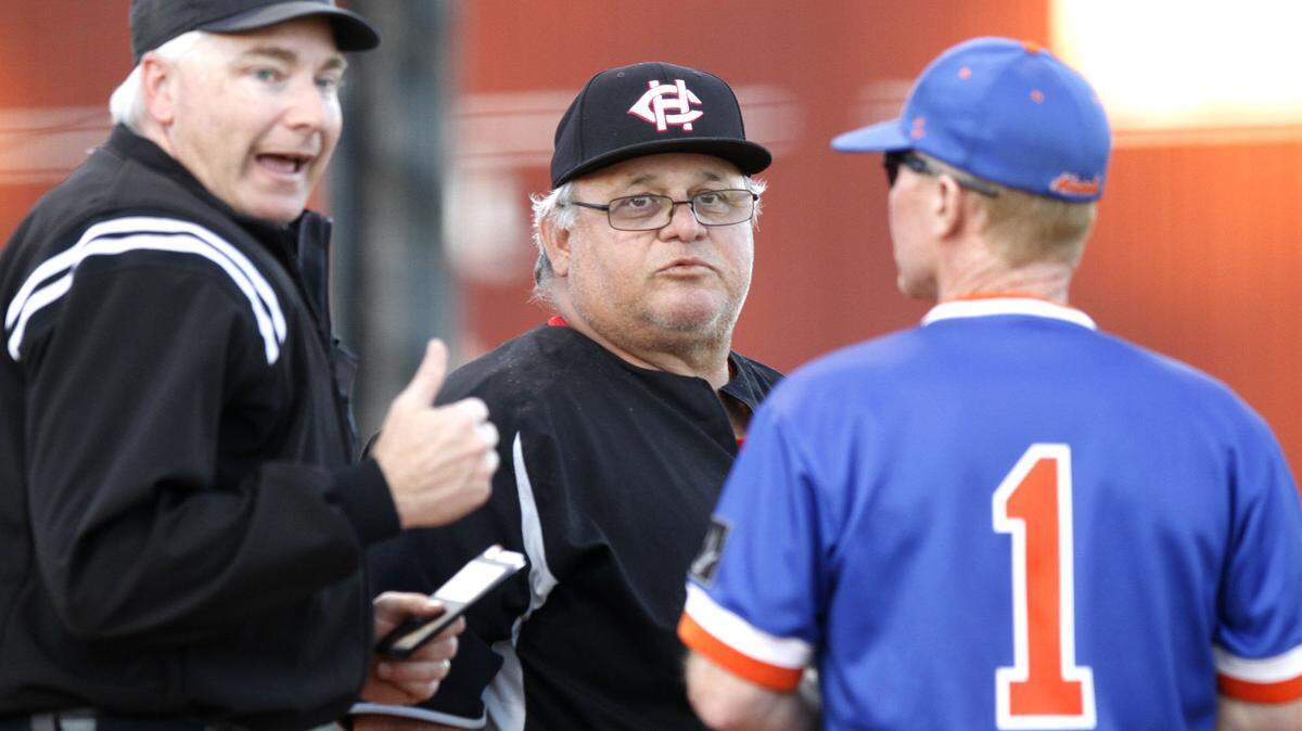 Harrison Central baseball coach Pat Olmi talks with Gulfport’s Jamie McMahon before the game starts, Monday, April 7, 2017. Olmi died on Dec. 16 at the age of 61.