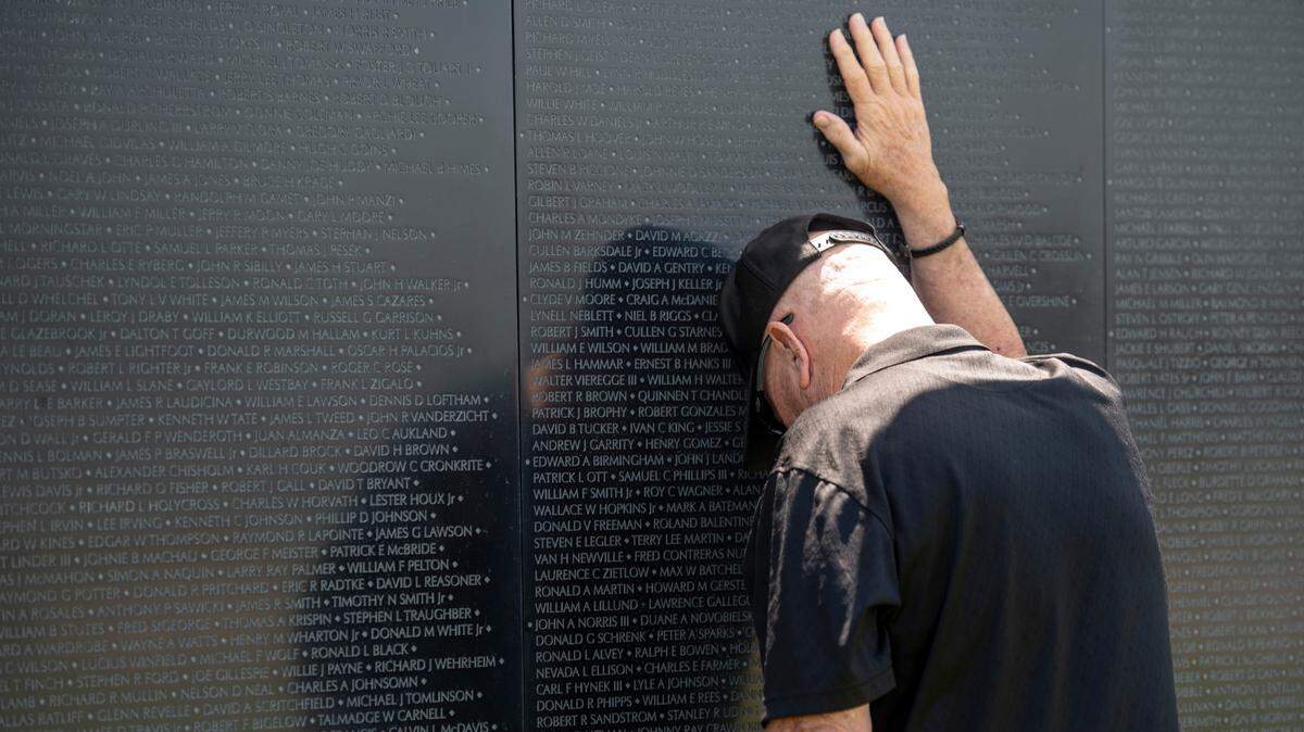Jerry Delahoussaye leans against The Wall That Heals, a traveling three-quarter scale replica of the Vietnam Veterans Memorial in D.C., while it is on display at the D’Iberville Sports Complex in D’Iberville on Thursday, April 10, 2025. Delahoussaye, a Vietnam veteran, has friends whose names are on the wall.