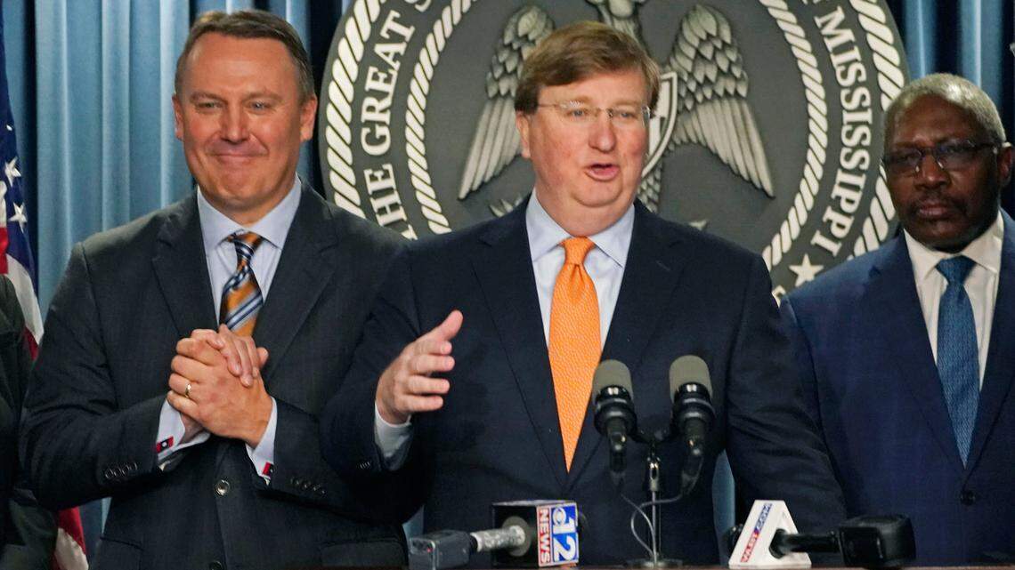 Mississippi Gov. Tate Reeves, center, announces a tech company will invest $10 billion to build two data processing centers that will create 1,000 jobs in central Mississippi, during a news conference in Jackson.