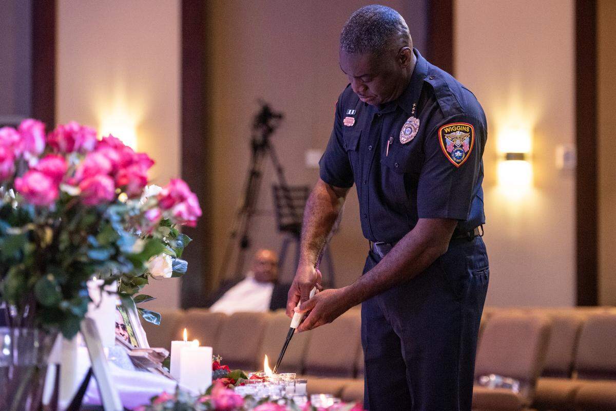 A police officer lights candles in honor of crime victims during a candlelight ceremony as a part of National Crime Victims’ Rights Week at First Baptist Church of Gulfport on Tuesday, April 23, 2024.