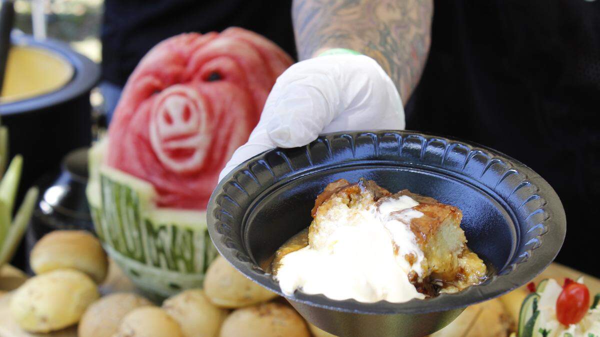 WESLEY MULLER/SUN HERALD 
 Hard Rock Executive Chef B.J. Creswell serves his award-winning jalapeno bread pudding at the Gulf Coast Symphony Orchestra's Barbecue Under the Oaks on Saturday, April 2, 2016.