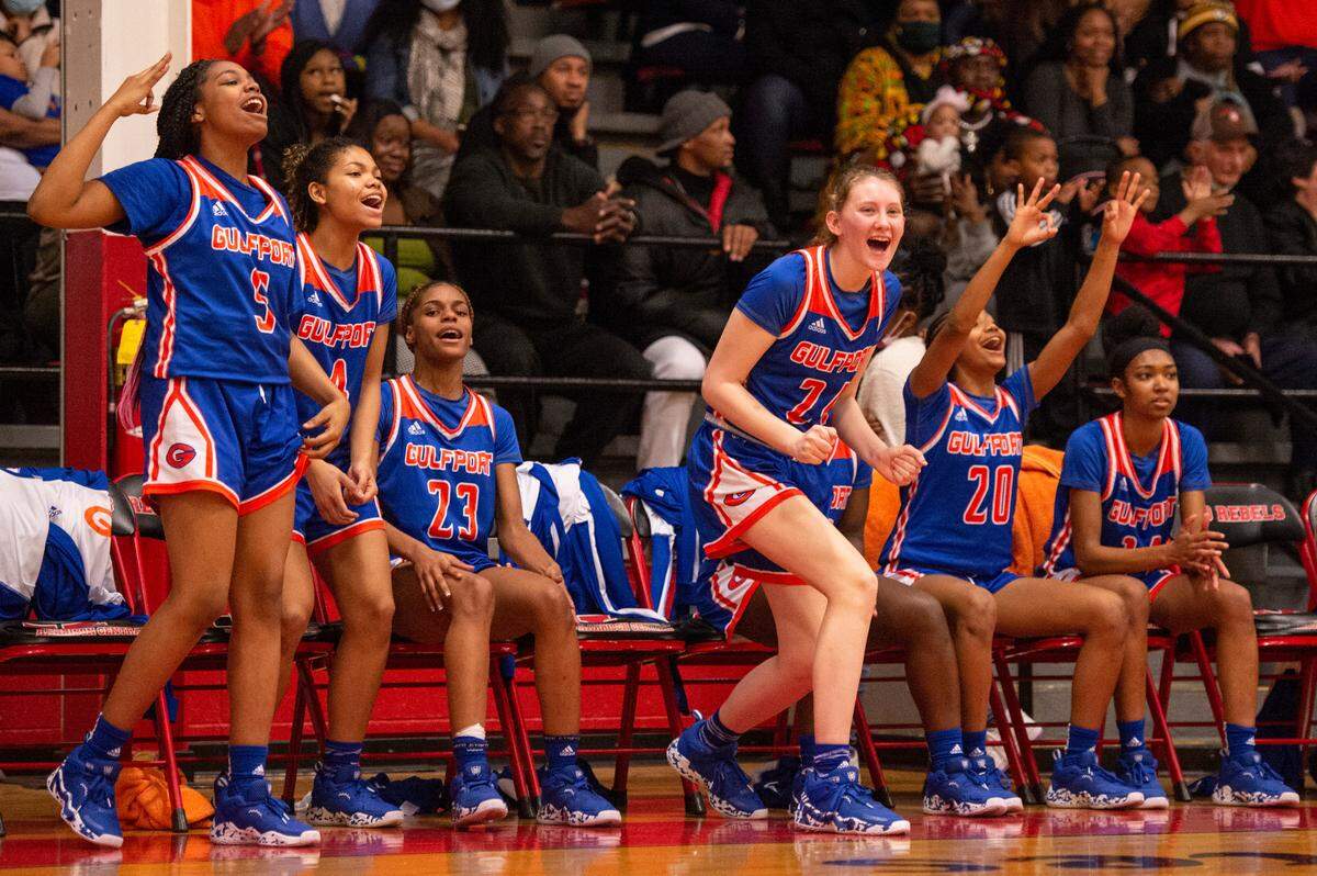 Members of Gulfport’s varsity girls basketball team cheer for Gulfport’s Simaru Fields during a game against Harrison Central at Harrison Central High School in Gulfport on Friday, Feb. 4, 2022.