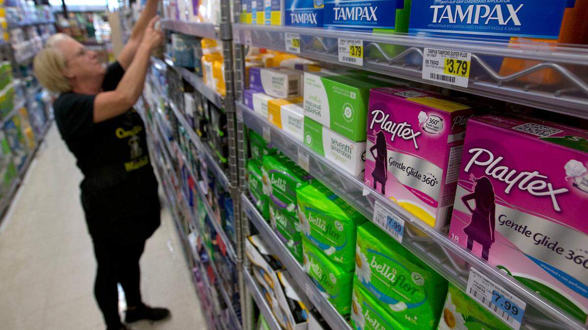 Feminine hygiene products are seen as Tammy Compton restocks a shelf at Compton’s Market, Wednesday, June 22, 2016, in Sacramento, Calif. A bill co-authored by Assemblywomen Cristina Garcia, D-Bell Gardens and Ling Ling Chang, R-Diamond Bar, to exempt tampons and other feminine hygiene products from sales tax was approved by the Senate Governance and Finance committee Wednesday.(AP Photo/Rich Pedroncelli)