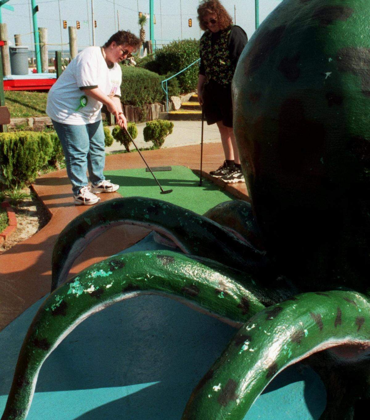 A tourist from Tennessee putts on the octopus hole at Fun Time USA in Gulfport in this 1998 file photo.