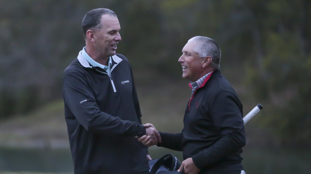 Kevin Sutherland and Scott Parel shake hands after playing five extra holes until play was suspended due to darkness during the 2019 Rapiscan Systems Classic. Sunday, March 31, 2019.