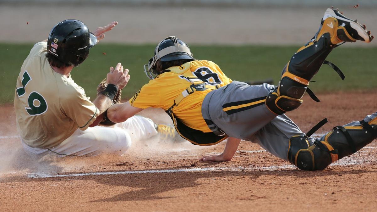 Southern Miss catcher Cole Donaldson tags Charlotte runner, Zack Smith (19) out at home plate during their game at MGM Park in Biloxi on Saturday.  Left fielder Gabe Montenegro made the toss to Donaldson on the play.