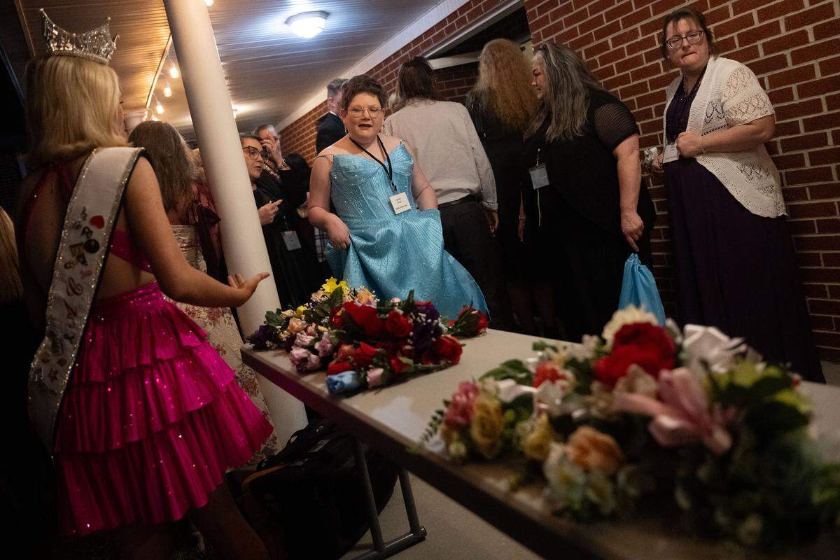 Guests of honor walk up to pick out a corsage as they arrive at Night to Shine at Woolmarket Baptist Church on Friday, Feb. 13, 2026.