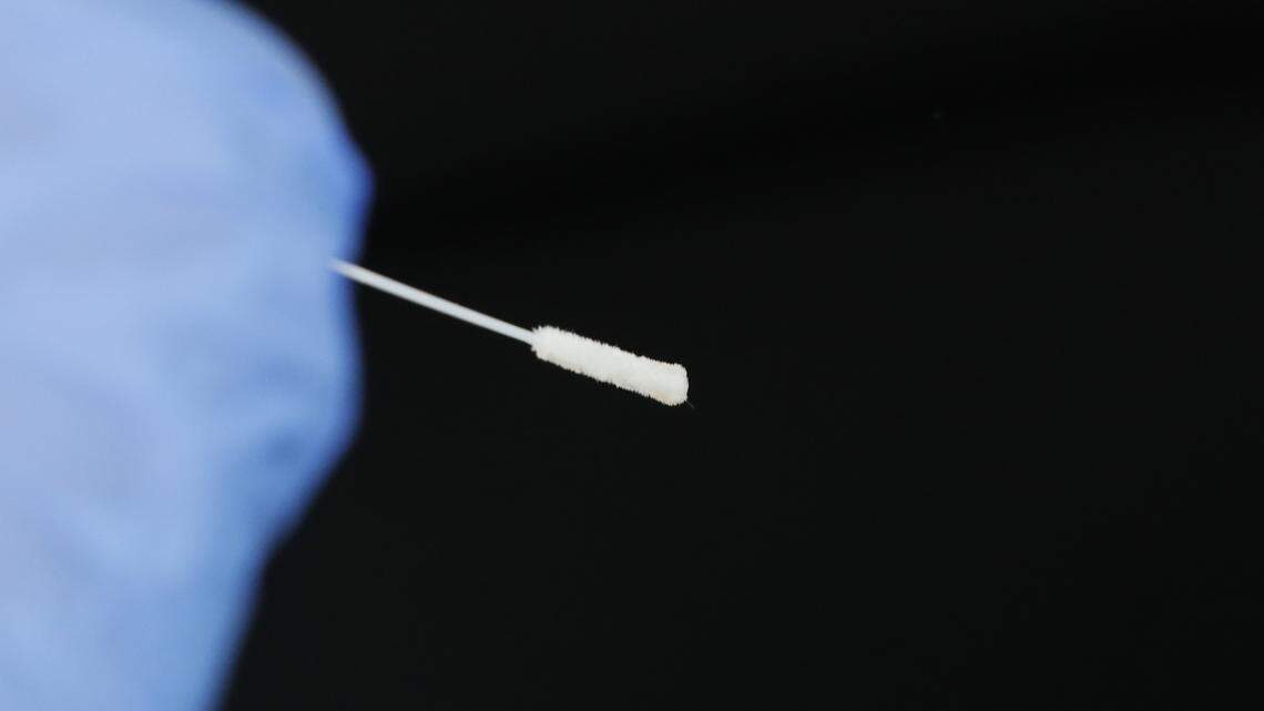 A nasal swab is held at ready by a Delta Health Center nurse as she waits to administer the free COVID-19 test at a drive-thru site at the center’s Dr. H. Jack Geiger Medical Center in Mound Bayou, Miss., Thursday, April 16, 2020.