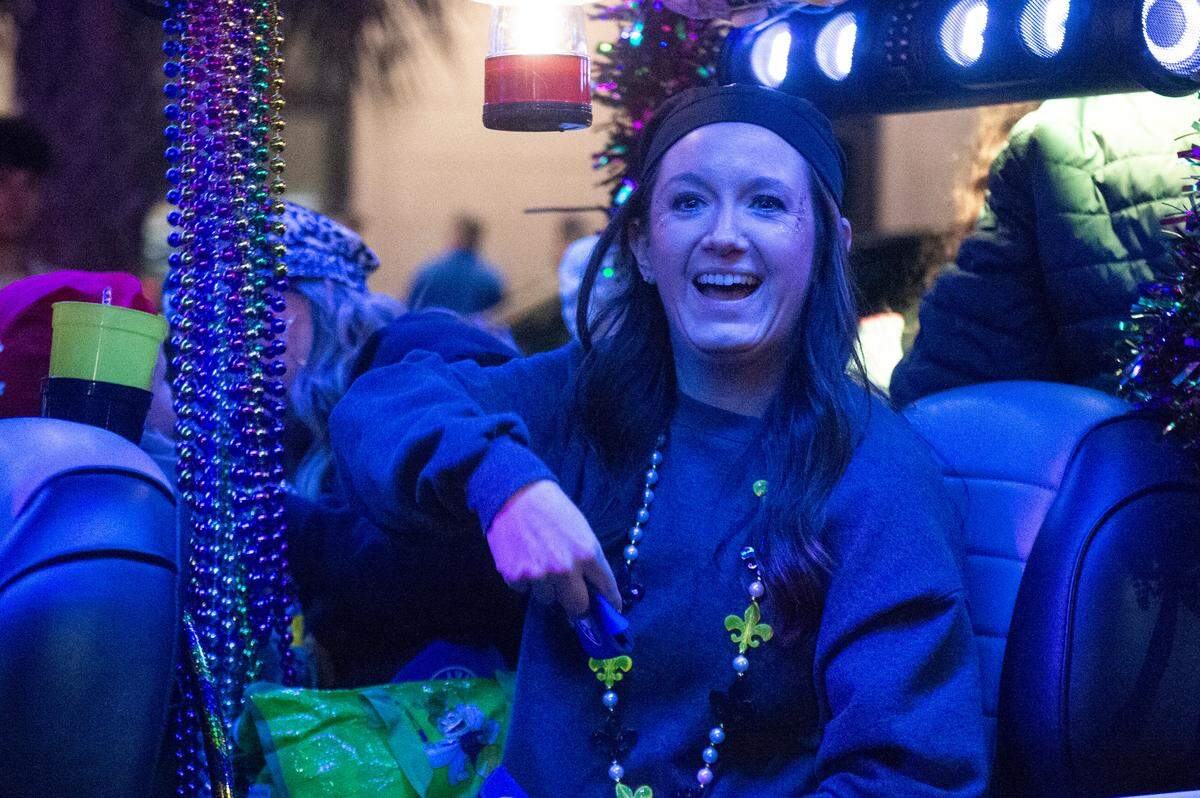 Members of Mystic Krewe of the Seahorse throw beads during the krewe’s Lundi Gras parade in Bay St. Louis on Monday, March 3, 2025.