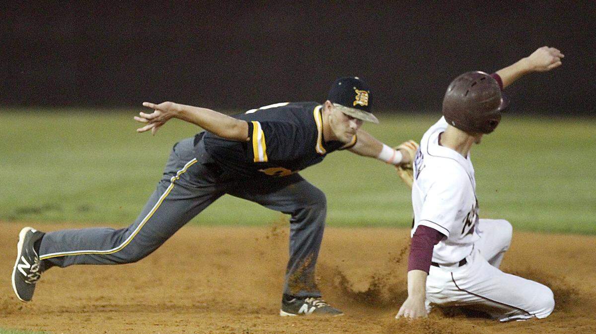 TIM ISBELL/SUN HERALD 
 D'Iberville's Nathan Yennie tags George County's Jacob Green at second, Friday, Apr. 15, 2016.