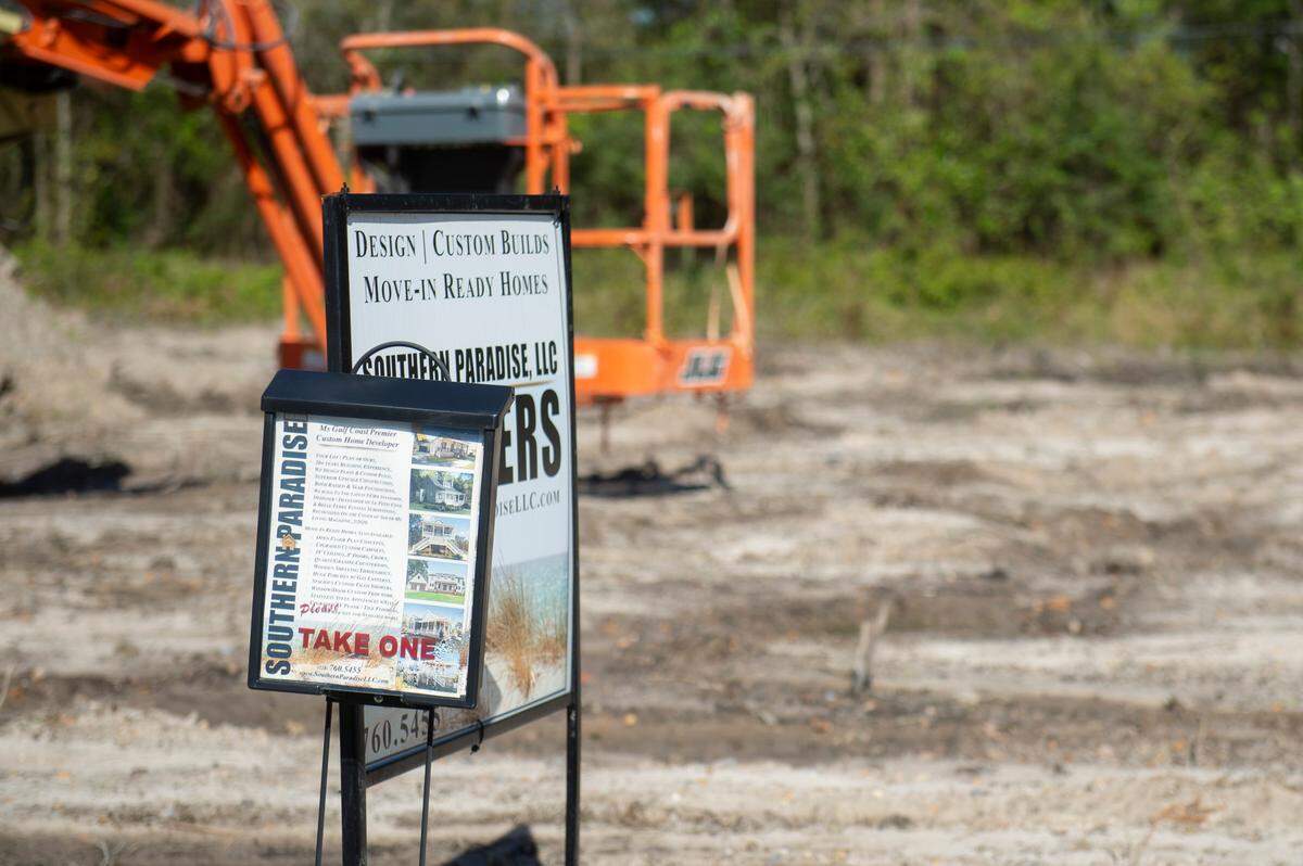 A sign on an empty lot advertising custom built homes at the Timber Ridge subdivision in Pass Christian on Tuesday, March 25, 2025.
