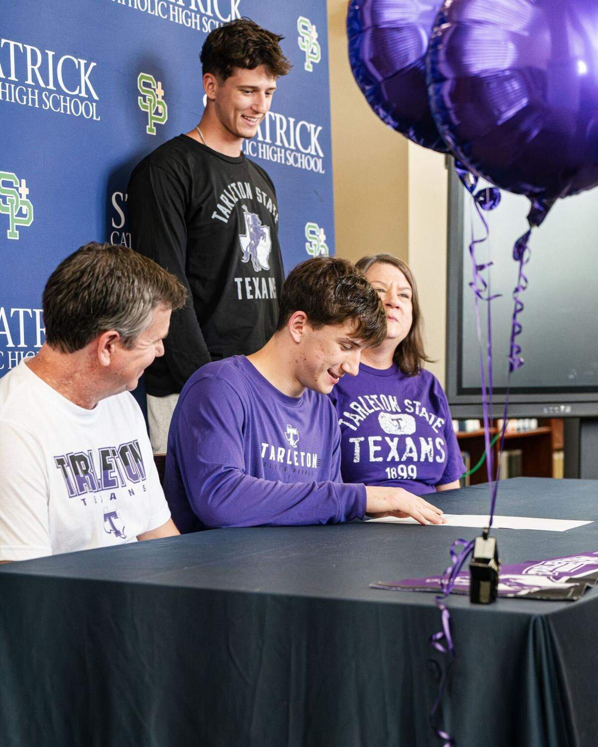 Matt Krass puts pen to paper at Tarleton State during his signing day ceremony at St. Patrick High School.