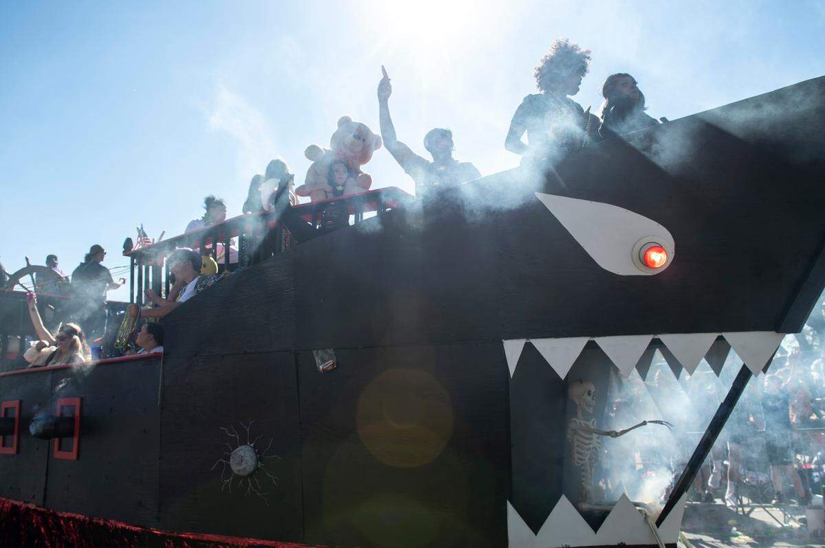 A pirate ship float with a shark’s mouth drives up Lameuse Street during the Gulf Coast Carnival Association Mardi Gras Parade in Biloxi on Tuesday, March 1, 2022.