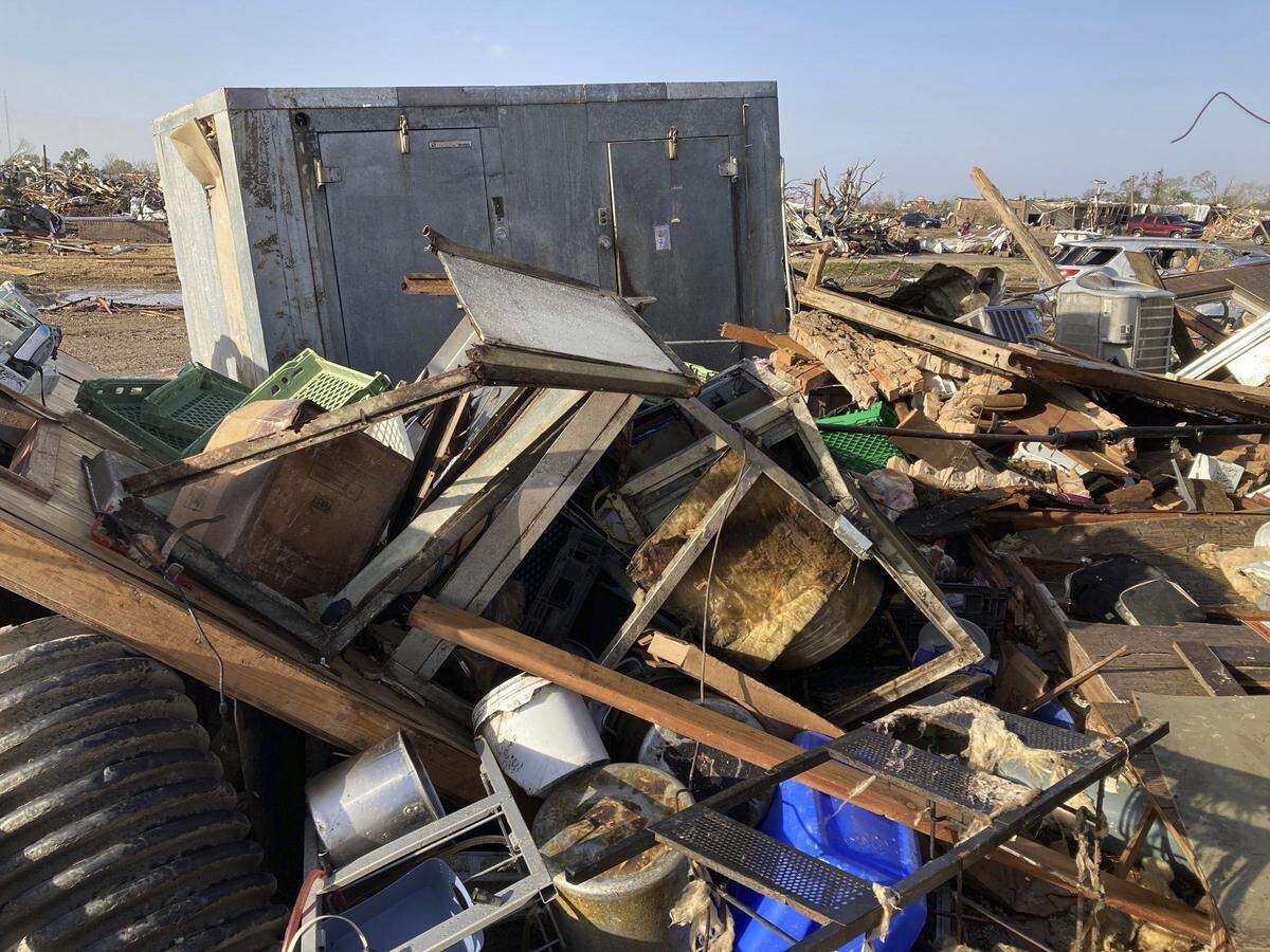 Debris covers the ground from a diner, Chuck’s dairy bar early Saturday, March 25, 2023 in Rolling Fork, Miss. The two owners and six employees survived the tornado Friday night by hiding out in the cooler when the building was hit the building is completely destroyed and is adjacent to the mobile home park. (AP Photo/Rogelio Solis)