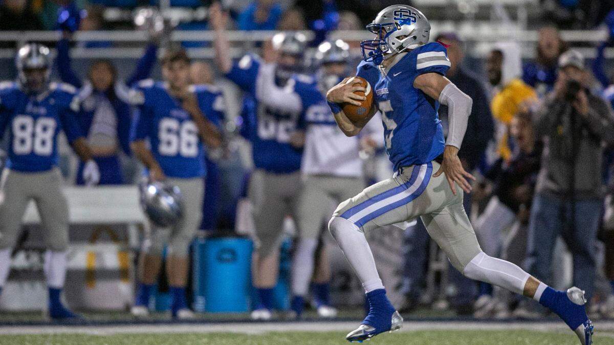 Ocean Springs quarterback Bray Hubbard runs down the field for a touchdown at Greyhound Stadium in Ocean Springs on Friday, Nov. 19, 2021.