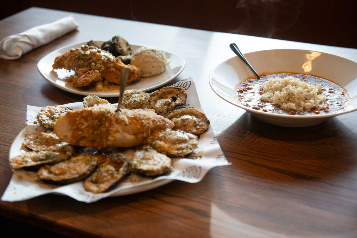 The catfish napoleon, chargrilled oysters and crawfish etouffe at Coterie Restaurant and Oyster Bar in Long Beach on Thursday, Dec. 14, 2023.