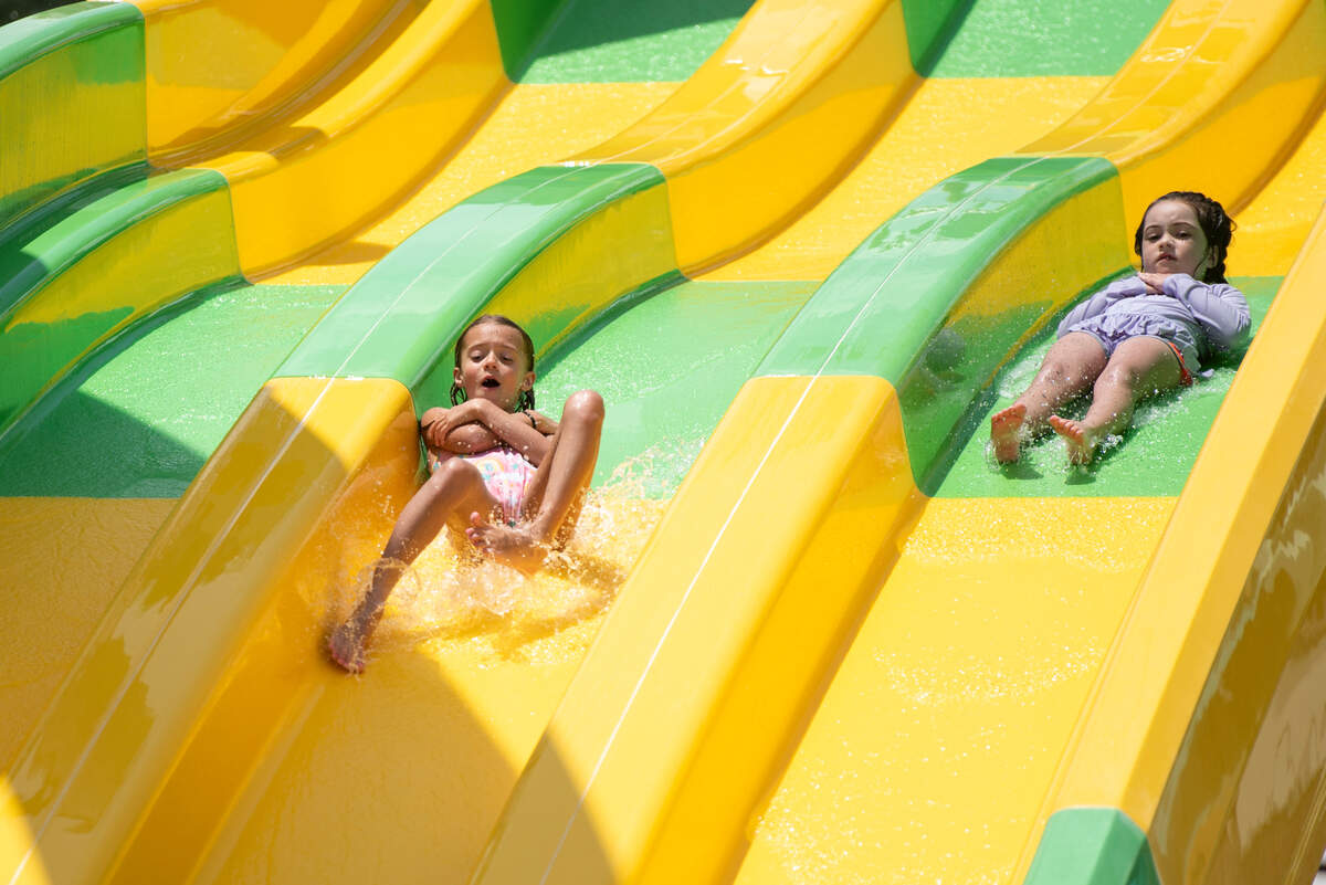 Kids slide down the Reptile Racers slide at Serengeti Springs at the Hattiesburg Zoo, a new waterpark that opened in May, on Wednesday, June 5, 2024.
