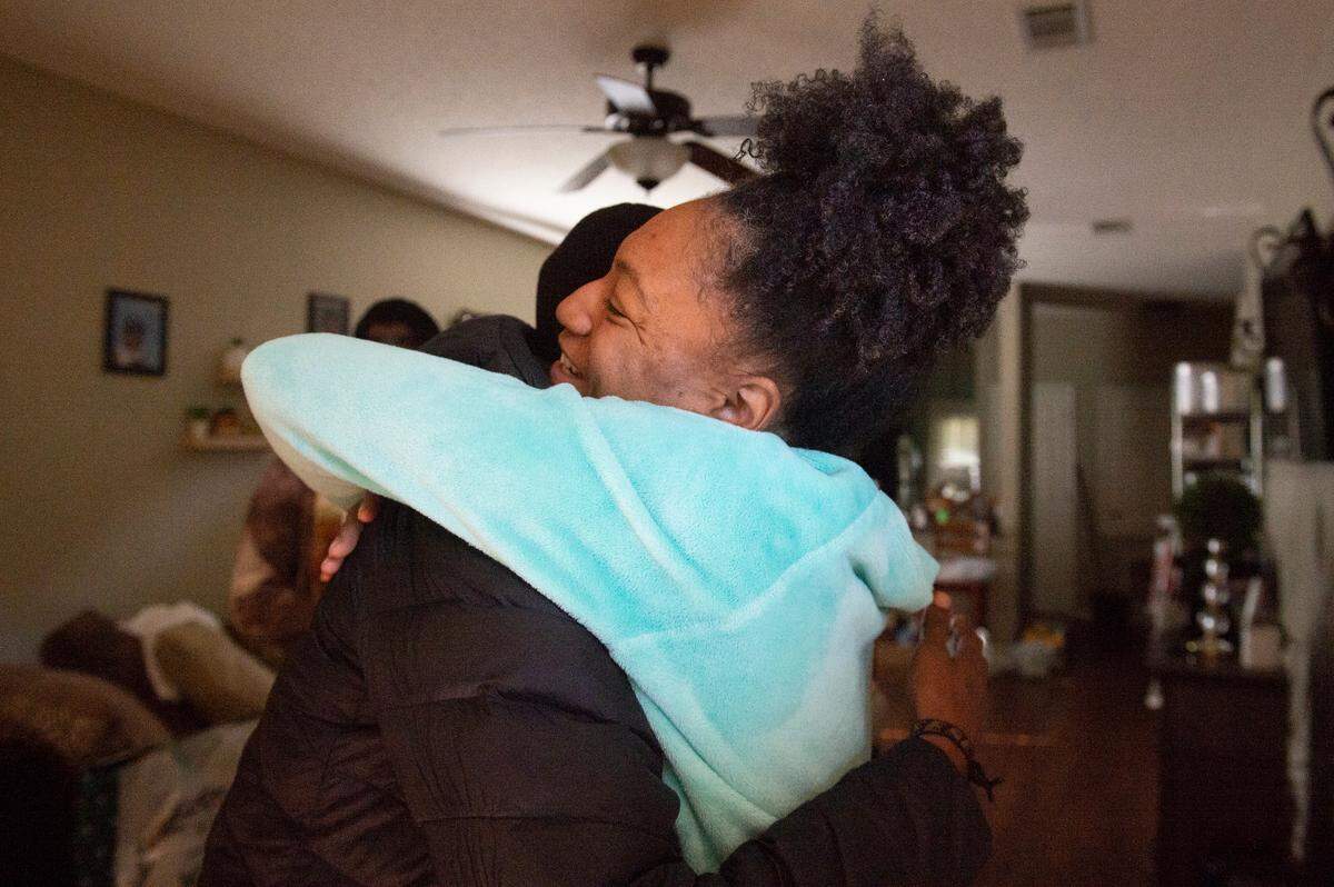 Olympian and Gulfport High School track coach Brittney Reese hugs Tanaya Smith, a caterer from Gulfport, as she delivers Christmas presents to Smith’s kids at Smith’s home in Gulfport on Friday, Dec. 23, 2022.