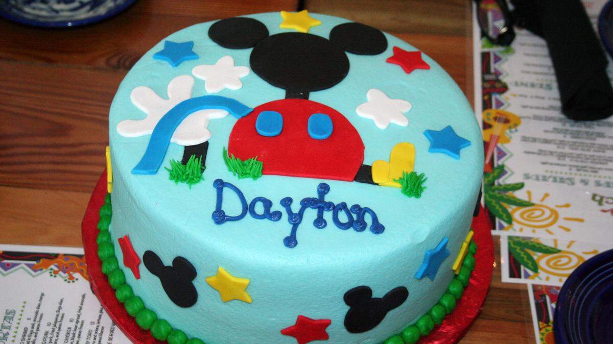 SHANNON DAVIDSON/SPECIAL TO THE SUN HERALDA Micky Mouse-themed cake, specially made for Dayton Premeaux, makes the occasion festive at his Make-A-Wish Foundation wish reveal at Baja Beach restaurant in Biloxi.