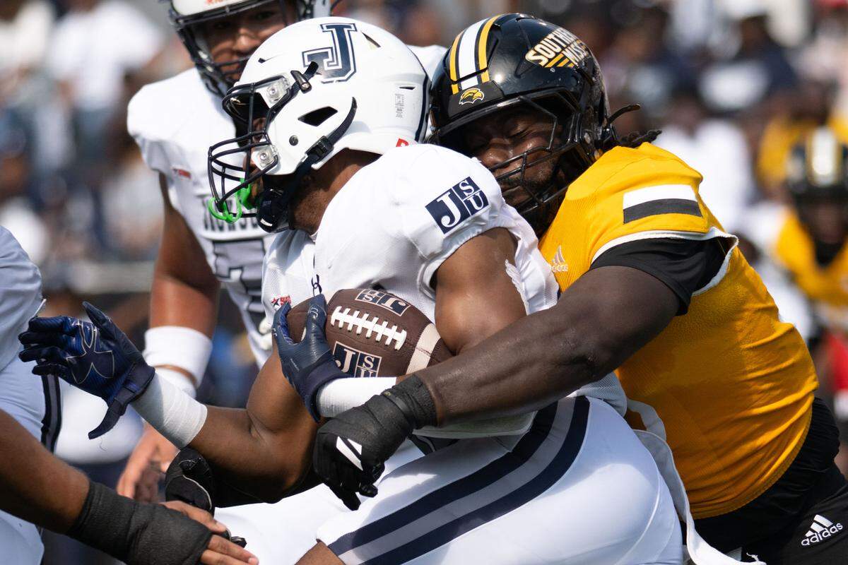 Southern Miss linebacker Chris Jones (35) tackles Jackson State running back Ahmad Miller (27).