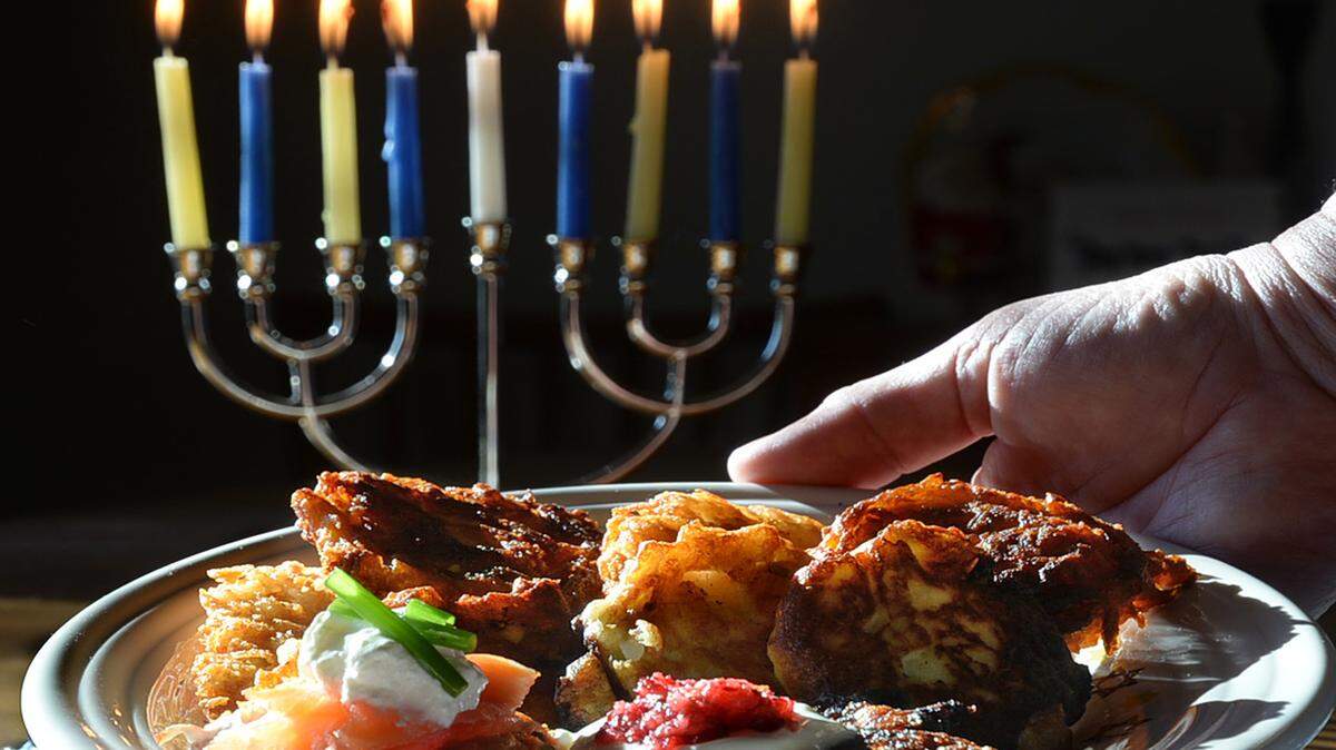DIEDRA LAIRD/CHARLOTTE OBSERVERLlatkes are grated potatoes fried and topped with sour cream and apple sauce.