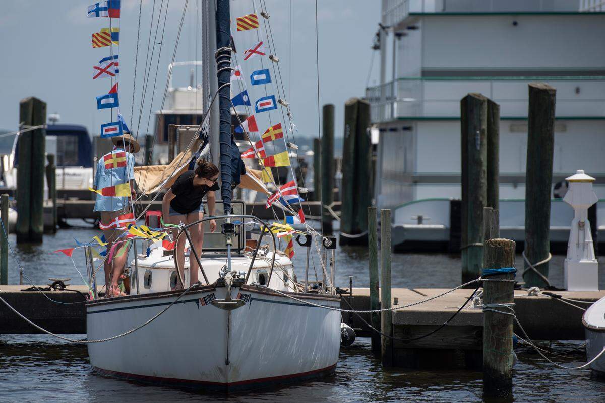 People prepare a boat during the Blessing of the Fleet in Biloxi on Sunday, May 28, 2023.