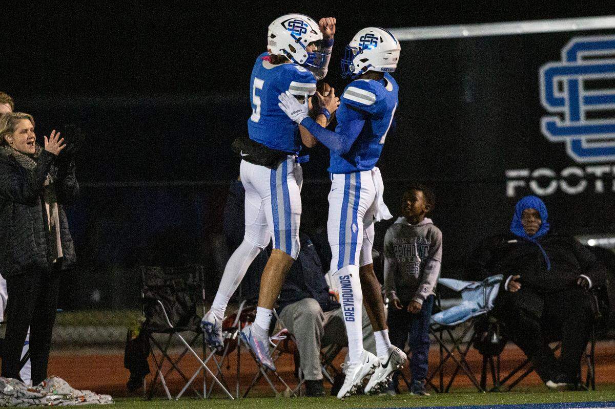 Ocean Springs’ quarterback Bray Hubbard and Christian White celebrate after scoring a touchdown against Oak Grove during a 6A playoff game at Greyhound Stadium in Ocean Springs on Friday, Nov. 18, 2022.