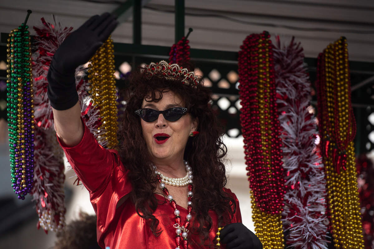 A float rider throws beads during The Ocean Springs Elks Carnival Parade in downtown Ocean Springs on Saturday, Jan. 27, 2024.