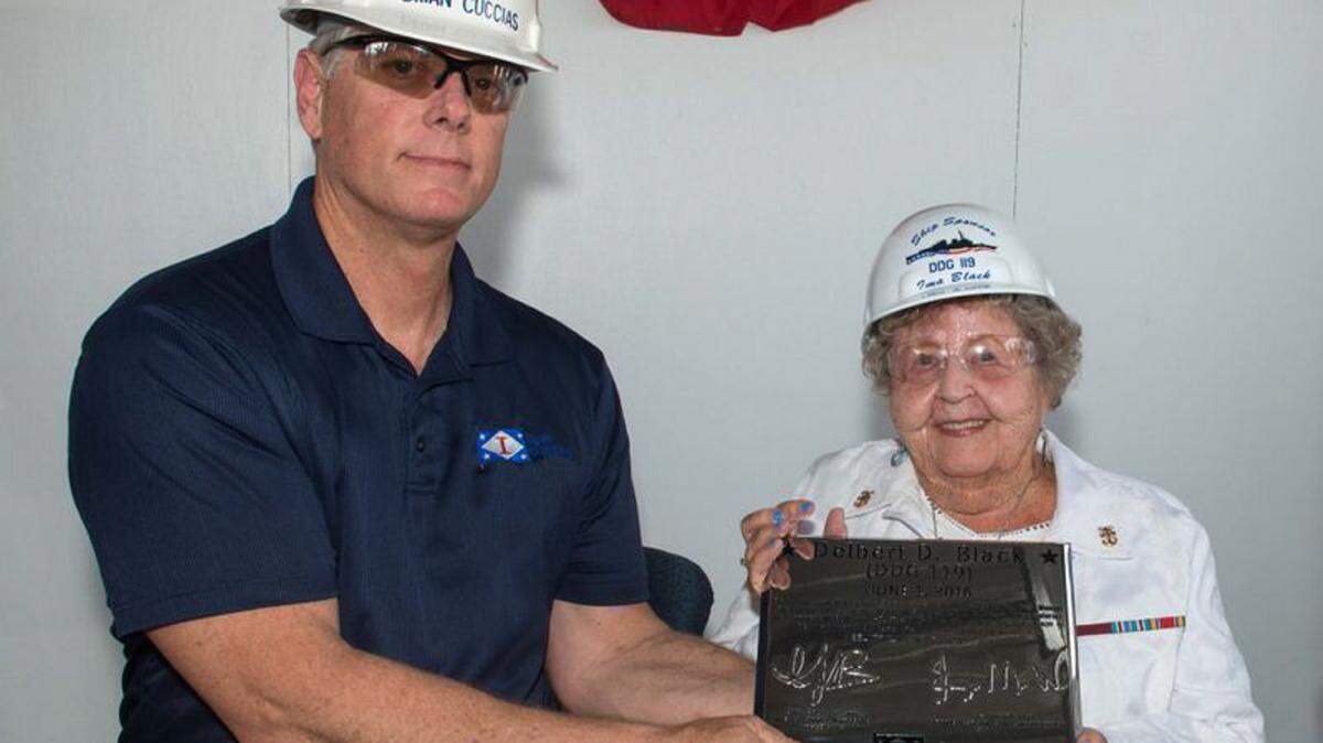 ANDREW YOUNG/HII 
 Ingalls Shipbuilding President Brian Cuccias presents a ceremonial keel plate to Ima Black, the sponsor of her husband's namesake ship, Delbert D. Black (DDG 119) on Wednesday.