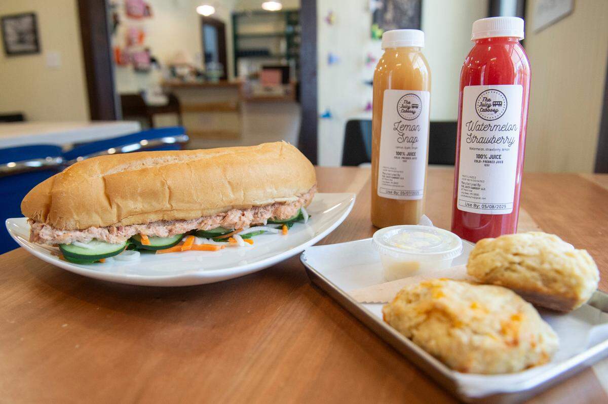 Menu options including biscuits from Greenhouse Biloxi, juices from The Juicy Caboosy and a coastal bahn mi sandwich at The Traveler, a new extension to the Walter Anderson Museum of Art, in Ocean Springs on Wednesday, April 16, 2025.