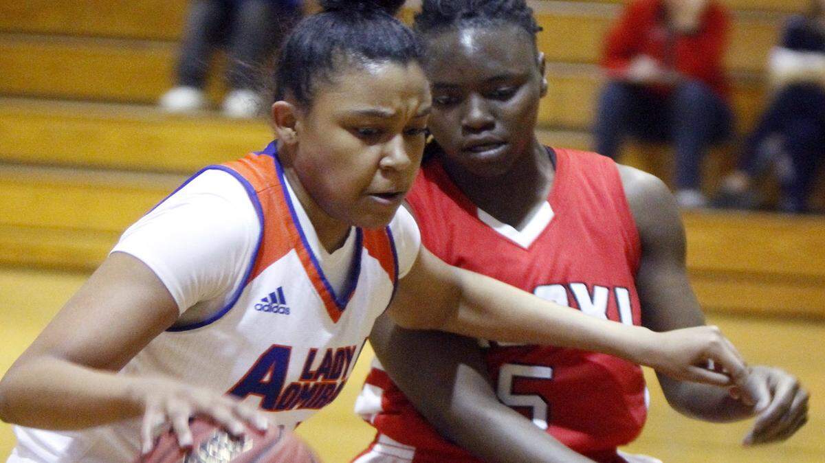 TIM ISBELL/SUN HERALD 
 Gulfport's Madisyn Collier drives the lane against Biloxi's Breanna Riley, Tuesday, Feb. 16, 2016.